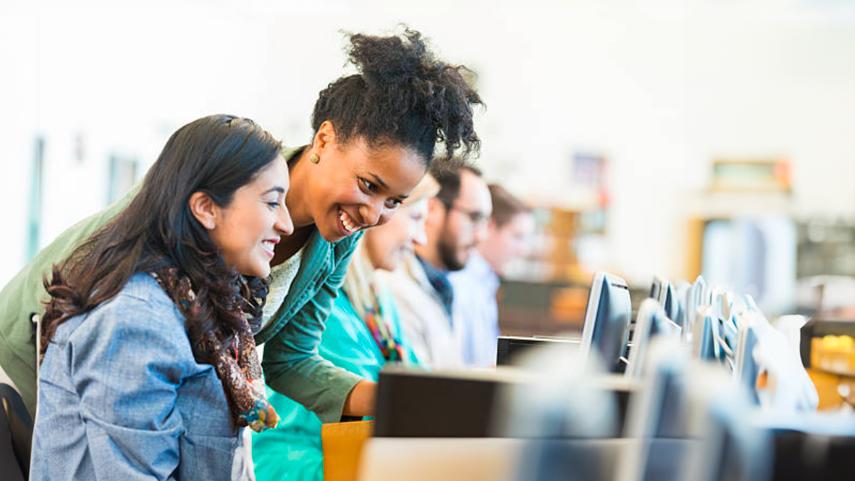 Student at computer with instructor